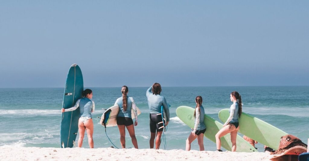 A group of surfers getting ready on a sunny beach in Rio de Janeiro, Brasil.