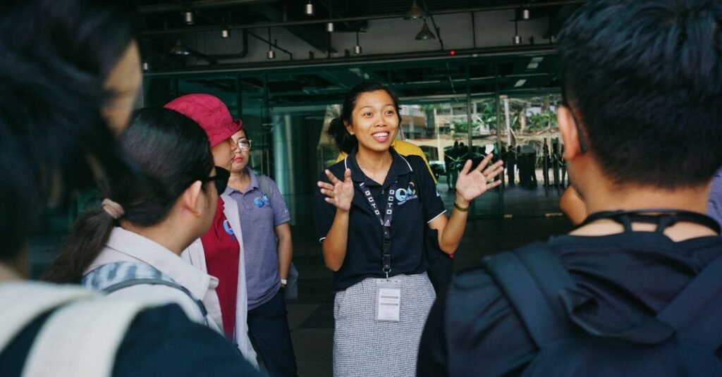 Tour guide leading a group tour, engaging visitors with gestures in an outdoor urban setting.