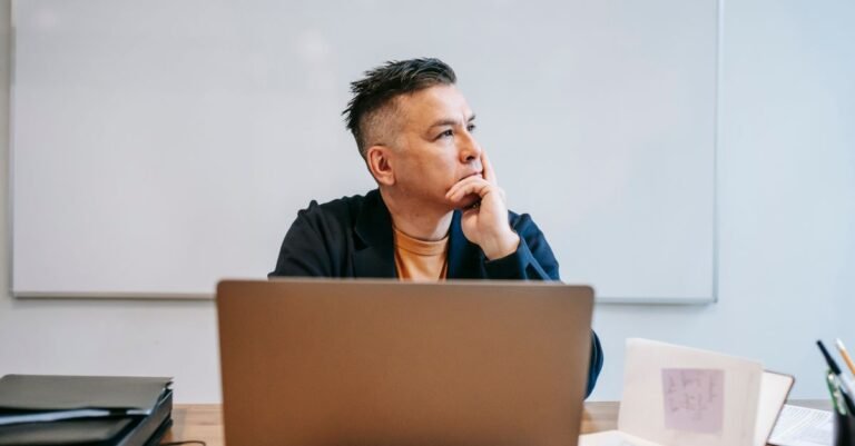 Focused businessman in home office, pondering work thoughts. Perfect for remote work and telecommuting concepts.