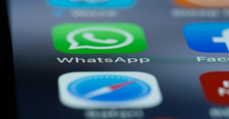Detailed close-up of a smartphone's home screen displaying popular applications like WhatsApp.